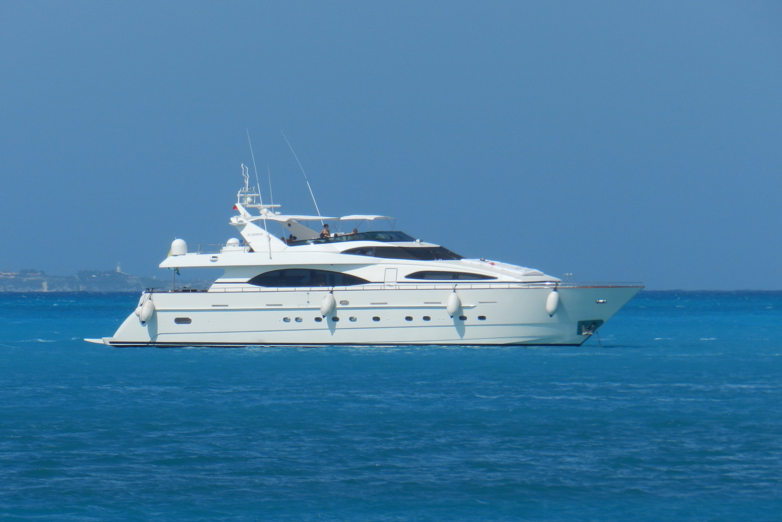 Serene Miami coastline with luxurious yachts sailing under the sunny sky.